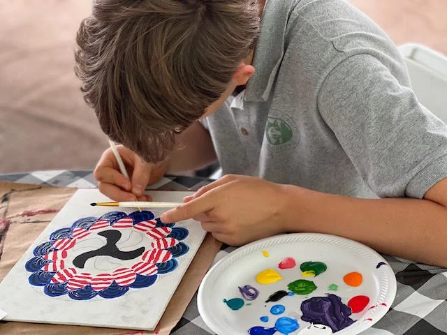 student painting on paper